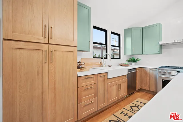 a kitchen with a sink stove and cabinets
