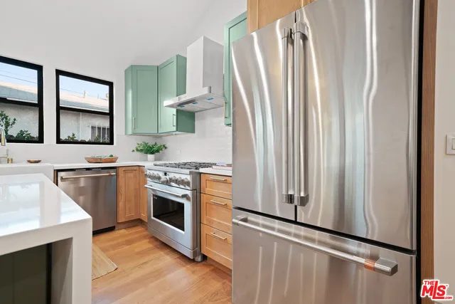 a kitchen with stainless steel appliances a stove and a refrigerator