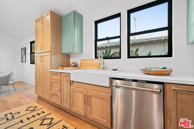a kitchen with stainless steel appliances a sink stove and a refrigerator