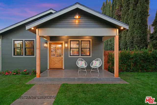 a front view of house with yard and outdoor seating