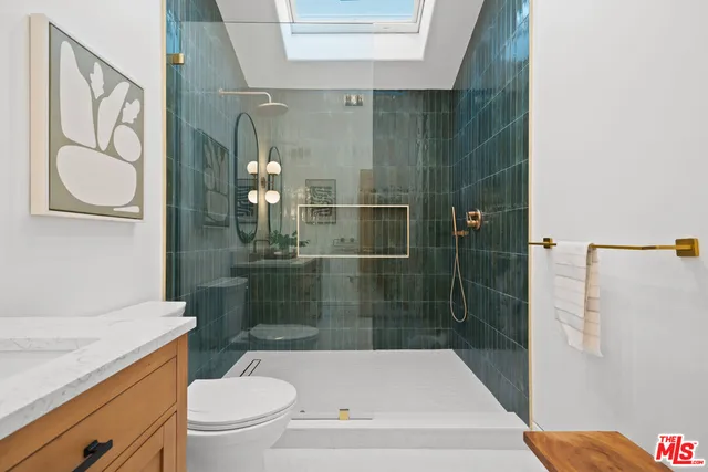 a bathroom with a shower a toilet and sink