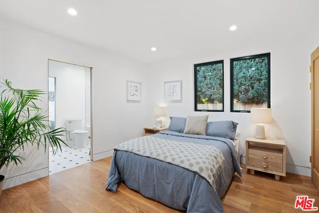 a bedroom with a bed and a large window