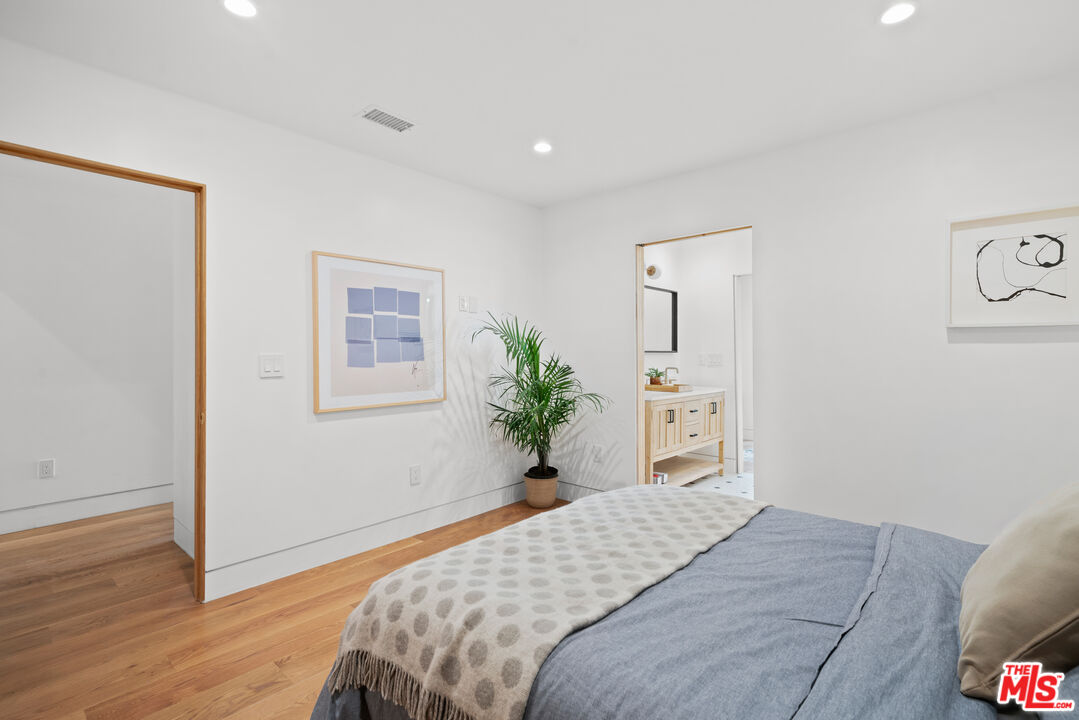 5252 Range View Avenue Los Angeles, CA 90042 - Photo 27 of 41 a bedroom with a bed and wooden floor
