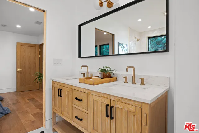 a bathroom with a sink a vanity and a mirror