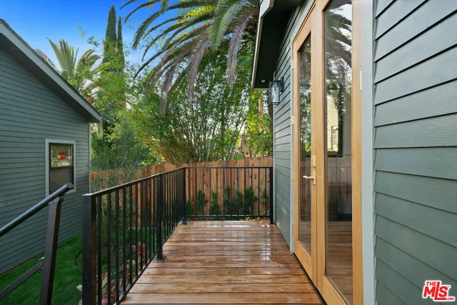a view of balcony with wooden floor and outdoor seating