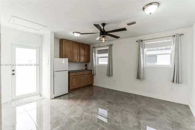 a kitchen with stainless steel appliances a refrigerator and a stove top oven