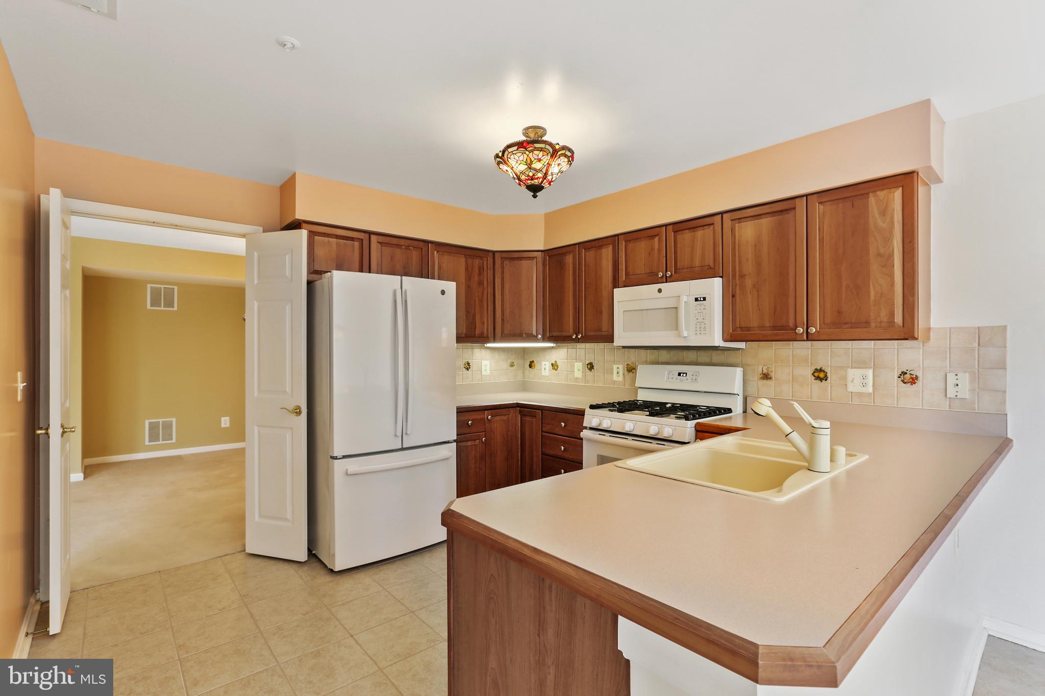 12300 Rosslare Ridge Road, Unit 304 Lutherville-Timonium, MD 21093 - Photo 12 of 18 Modern kitchen with white appliances