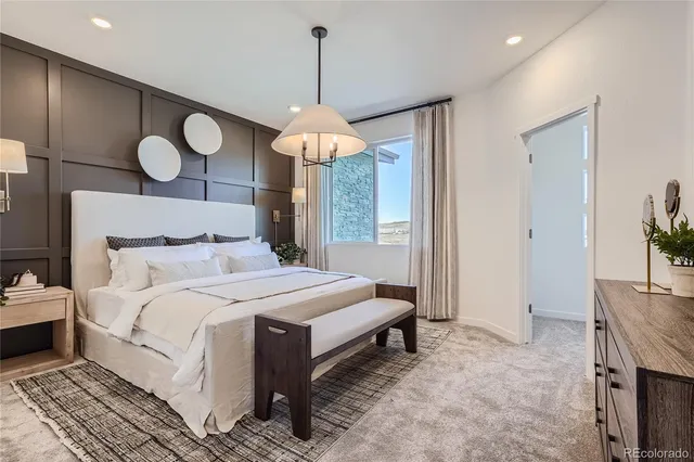 a bedroom with bed and a chandelier