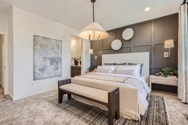 a bedroom with a bed and chandelier