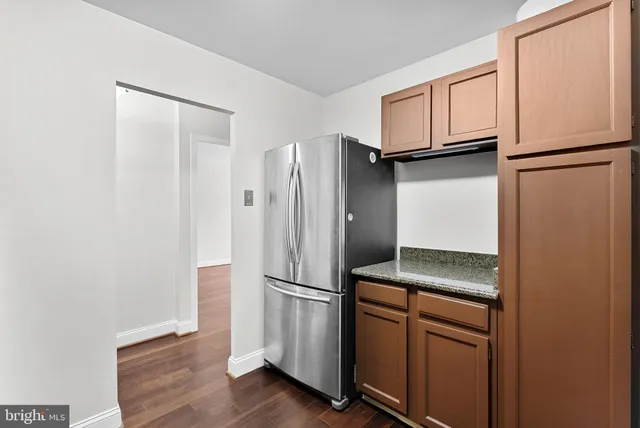 a kitchen with stainless steel appliances a refrigerator and cabinets