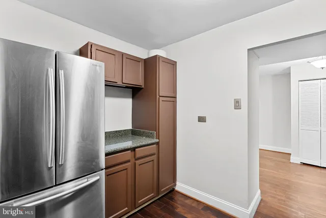 a kitchen with stainless steel appliances granite countertop a refrigerator and a sink