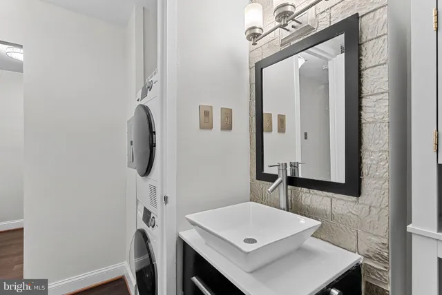 a bathroom with a sink a mirror and vanity