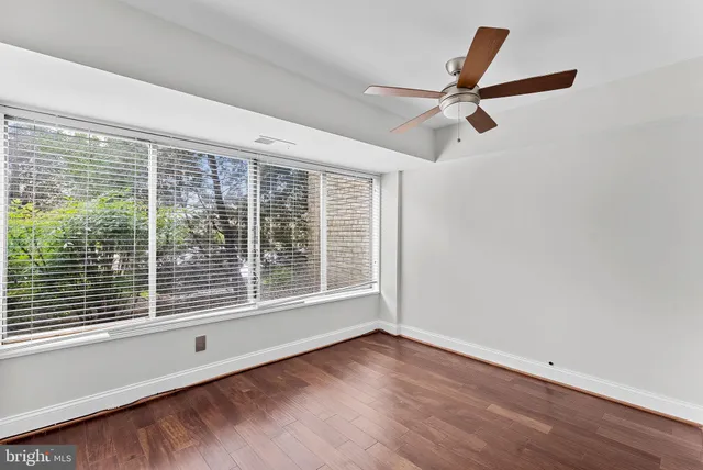 a view of a livingroom with a ceiling fan and window