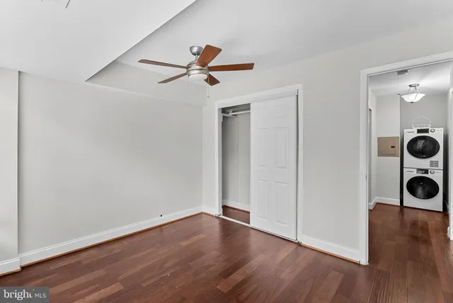 a view of a room with wooden floor and windows
