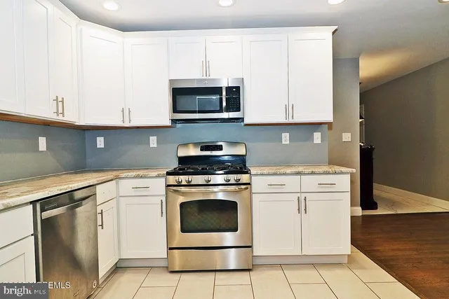 a kitchen with cabinets appliances and a sink