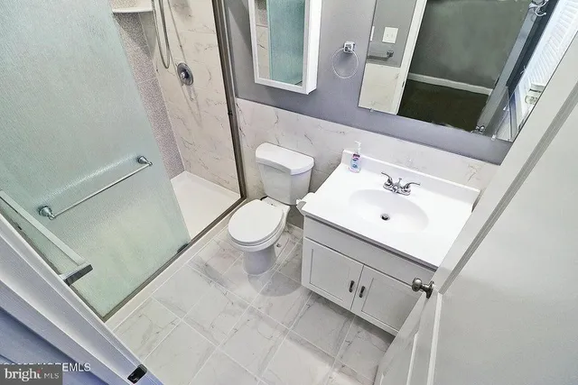 a bathroom with a shower and a toilet