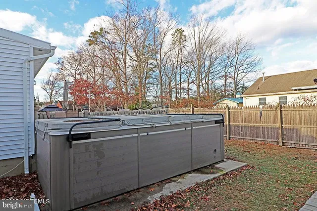 a view of a roof deck with table and chairs with wooden floor and fence