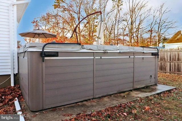 a view of a house with a small yard and wooden fence