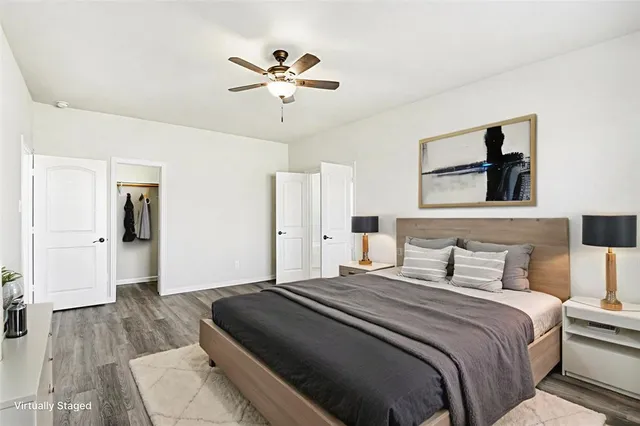 a spacious bathroom with a tub sink and mirror