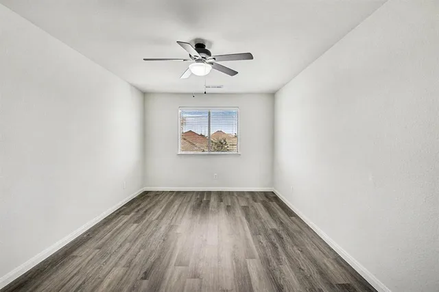 a bathroom with a bathtub shower sink vanity mirror and toilet