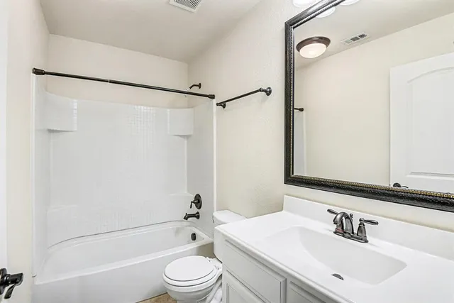 a view of an empty room and wooden floor