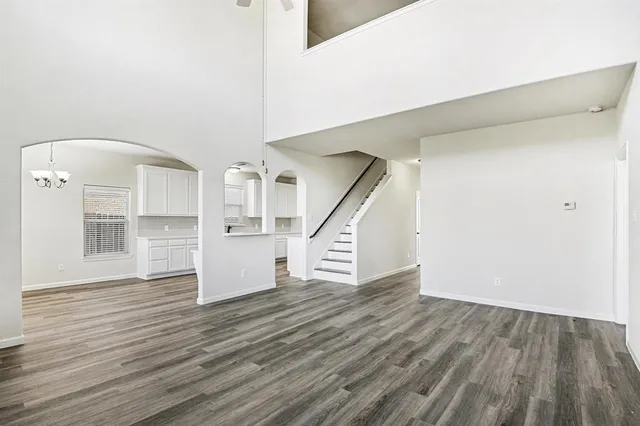 a large kitchen with kitchen island white cabinets and stainless steel appliances