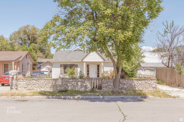 330 West 600th Street South Provo, UT 84601 - Photo 1 of 26 White siding residence featuring a stone-clad retaining wall and a mature front yard tree