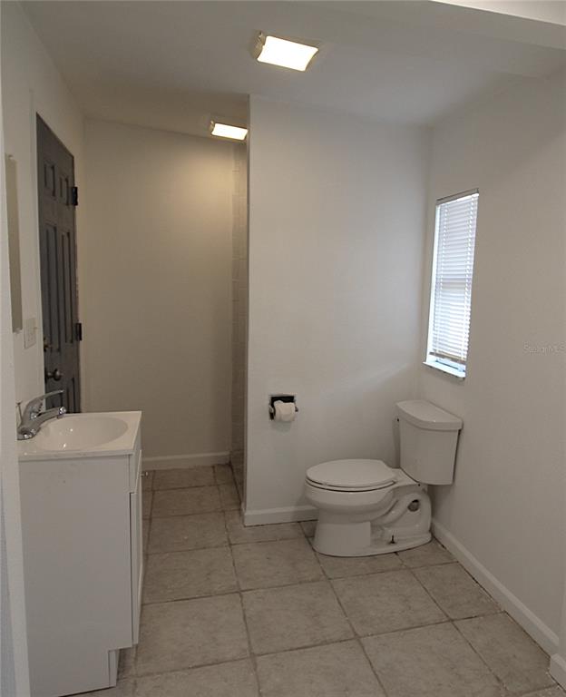 2345 Floyd Street Sarasota, FL 34239 - Photo 13 of 18 a bathroom with a sink a toilet and a mirror