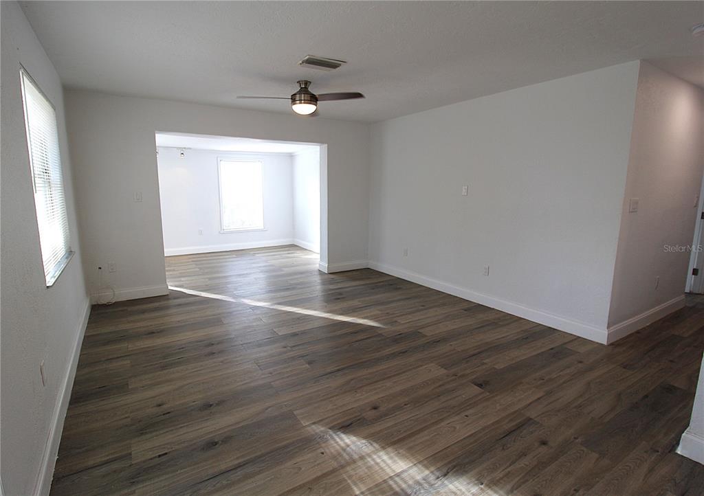 2345 Floyd Street Sarasota, FL 34239 - Photo 4 of 18 a view of an empty room with wooden floor and a window