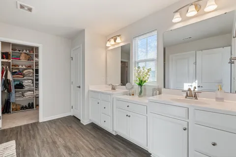 a bathroom with a double vanity sink and a mirror