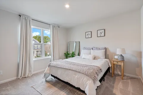 a bedroom with a large bed and a window