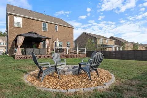 a view of a chair and table in backyard