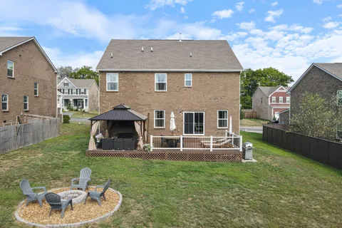 a aerial view of a house with a yard porch and furniture