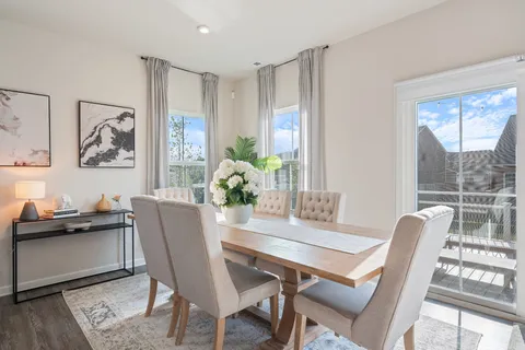 a dining room with furniture and window