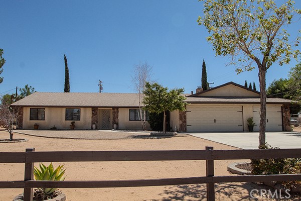 20515 Shawnee Road Apple Valley, CA 92308 - Photo 1 of 1 a front view of a house with garden
