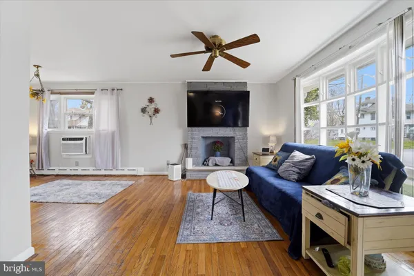 a living room with furniture a rug and a flat screen tv