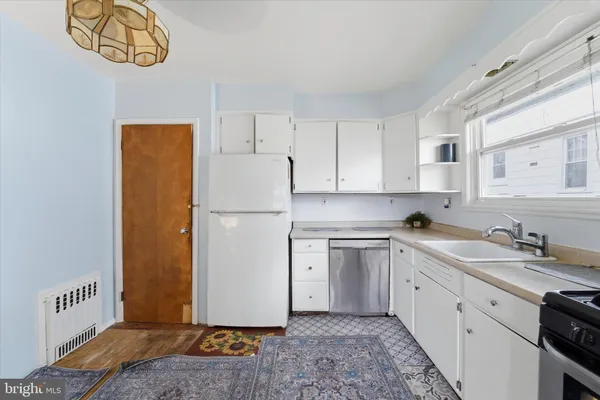 a kitchen with a refrigerator and a sink