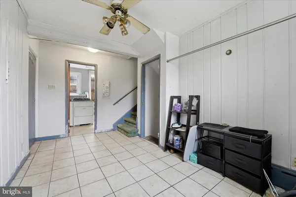 a view of a hallway with workspace and closet