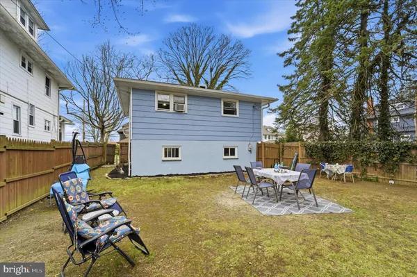 a view of a chairs and table in backyard of the house