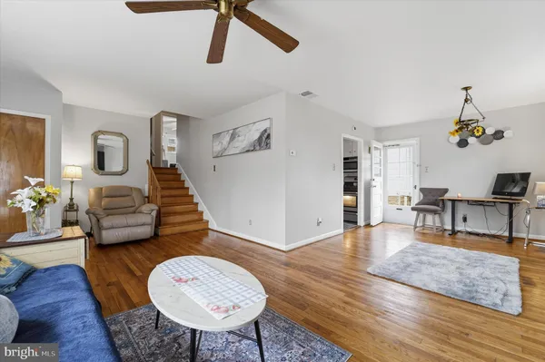 a living room with furniture and a wooden floor