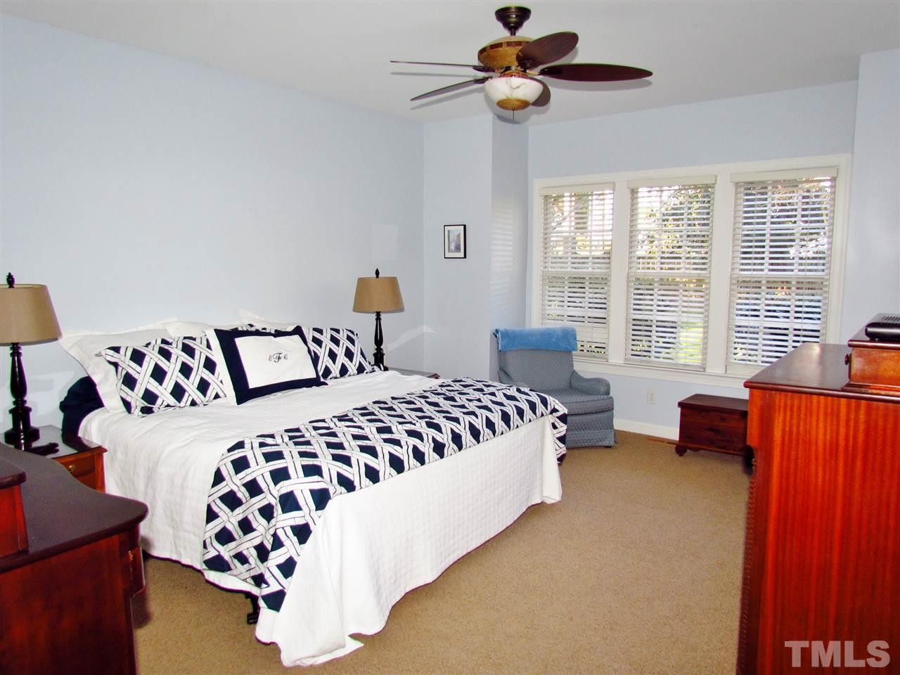 513 Tufts Court Raleigh, NC 27609 - Photo 14 of 25 a bedroom with a bed couch and window