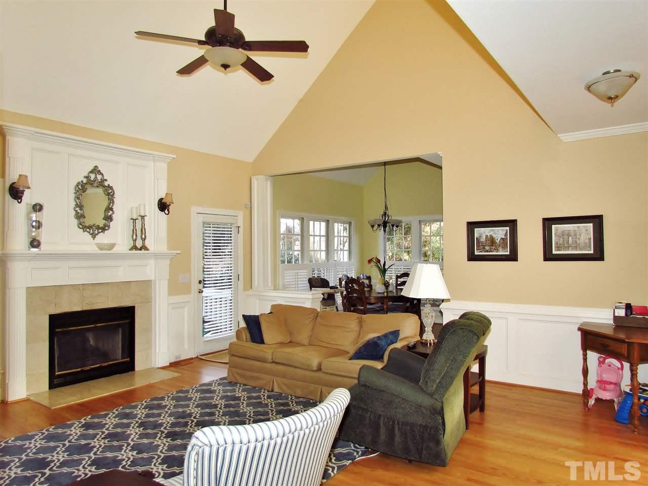 513 Tufts Court Raleigh, NC 27609 - Photo 5 of 25 a living room with furniture a rug and a fireplace