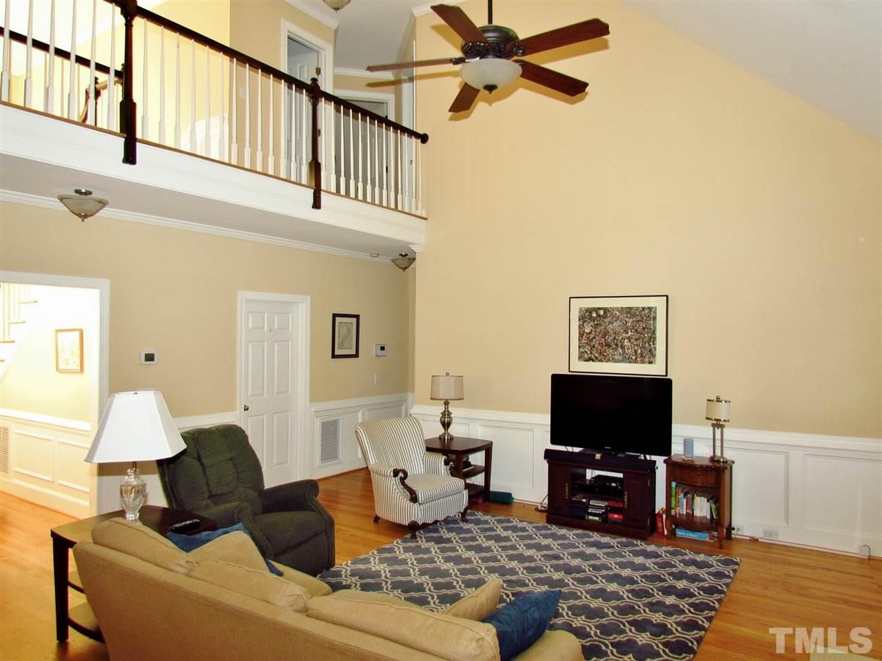 513 Tufts Court Raleigh, NC 27609 - Photo 6 of 25 a living room with furniture and a flat screen tv