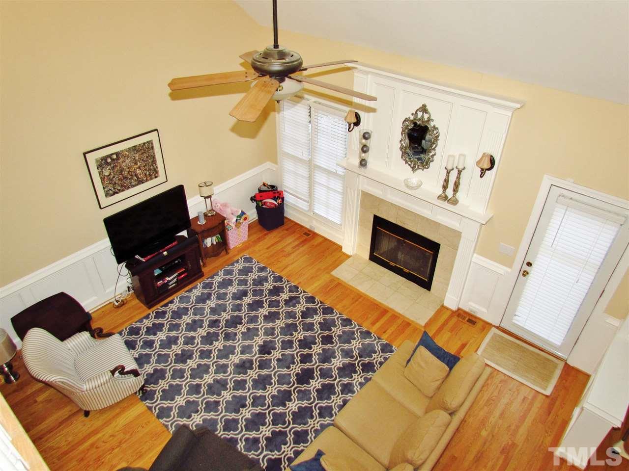 513 Tufts Court Raleigh, NC 27609 - Photo 7 of 25 a living room with a couch and a flat screen tv