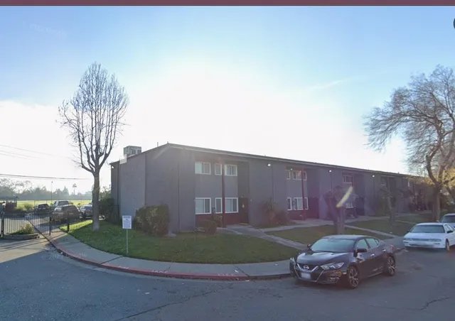 a car parked in front of a white house