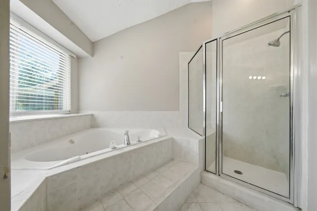 a bathroom with a bathtub and a shower