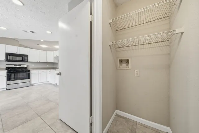 a view of a kitchen with electric appliances