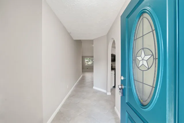an entryway with wooden floor and a hallway