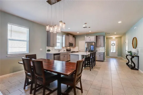 a living room with furniture and kitchen view