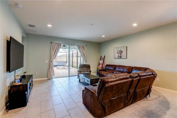 a bedroom with a large bed and a tv